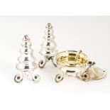 A modern three piece cruet set from Garrard, the abstract conical and waisted salt and pepper on