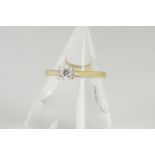 An 18ct gold diamond solitaire, the brilliant cut in four claw setting with yellow gold shank