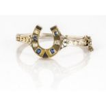 An Edwardian sapphire and diamond gold bangle, the hinged bangle of pierced design with horseshoe