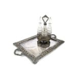An early Victorian cut glass and silver plated condiment set, having four bottles with tops and