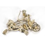 An American gilt metal costume brooch, modelled as an Egyptian archer upon a horse drawn chariot,