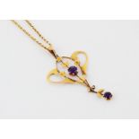 A 9ct gold Art Nouveau amethyst drop pendant, on an oval linked chain, 4.2g