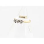 A three stone diamond dress ring, the platinum set old cuts in claw illusion settings on a yellow