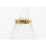 An Edwardian 18ct gold ruby and diamond three stone ring, the old cut diamond in gypsy setting