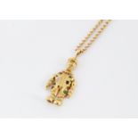 A 9ct gold multi gem set clown pendant and chain, the articulated pendant set with circular cut