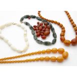 Two simulated amber graduated bead necklaces, a moss agate necklace and two other necklaces, one