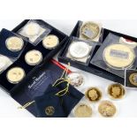 A collection of proof like coins and medallions and stamps, including a seven coin Dunkirk Little