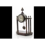 A late 19th century mantle clock, drum 30 hour movement in wooden surround having vase and flower