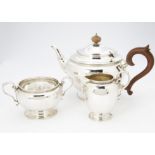 An Art Deco three piece silver tea set by ISG, Birmingham 1929, 35 ozt, with socle bases and stylish