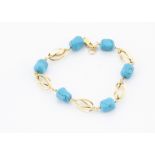 An 18ct gold and turquoise bracelet, the faceted rough beads alternately set with openwork gold