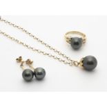 A 14ct gold Tahitian black pearl and diamond set dress ring, the spherical black pearl flanked by