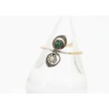 A Belle Epoque emerald, diamond and pearl set dress ring, the platinum set gems in a scroll