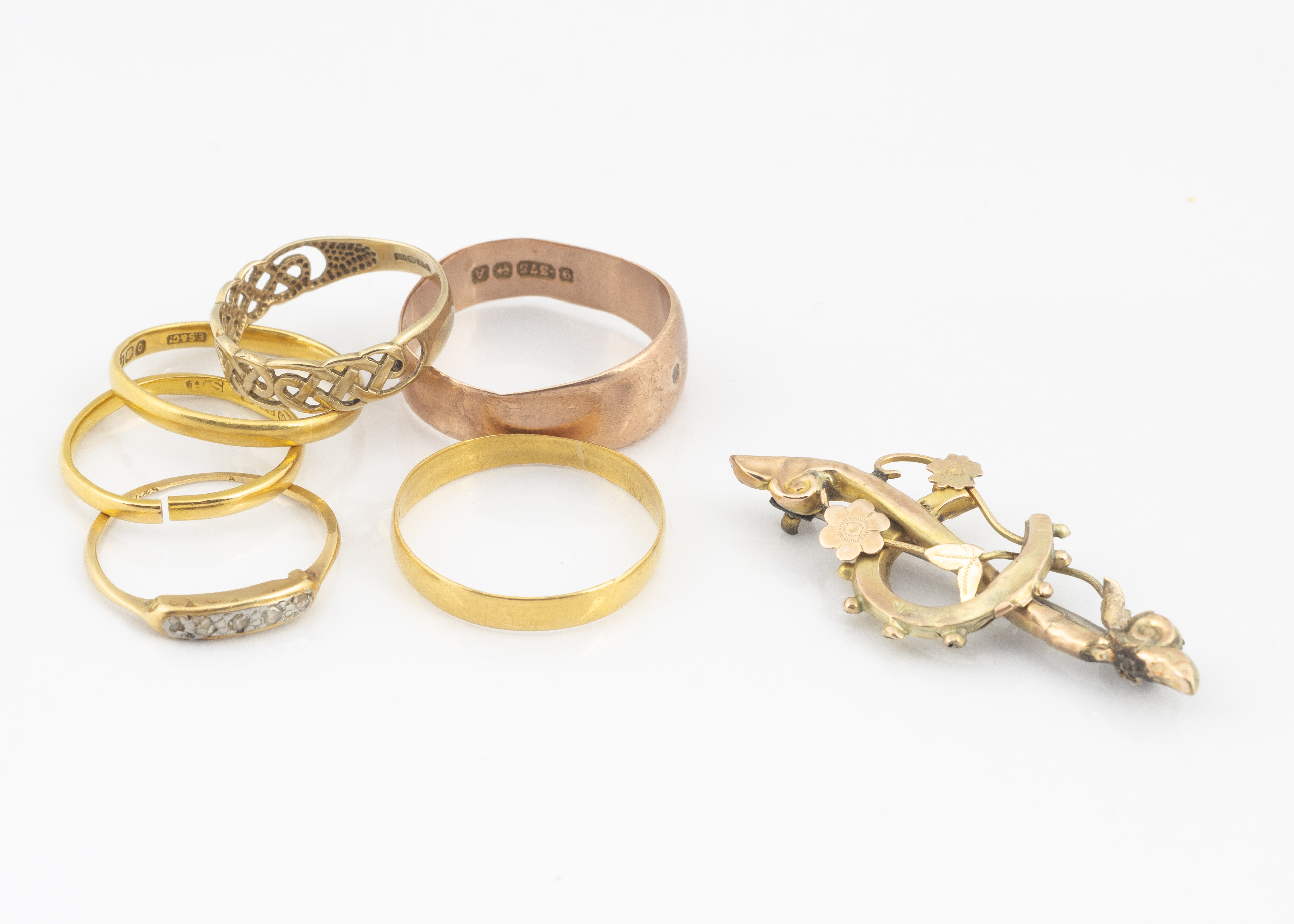 Three 22ct gold wedding bands, 5.1g, a diamond chip gold ring (af), two 9ct gold rings and a 9ct