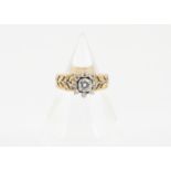 A continental yellow metal and diamond cluster dress ring, the raised brilliant cut diamond in a