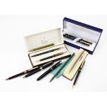 A small group of pens, including a modern Waterman fountain pen and roller ball set in a box, a