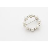 A continental white metal cultured pearl and diamond wreath brooch, with pin back marked 585 to