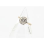 A 1960s 18ct gold diamond cluster ring, the brilliant cut central diamond in illusion setting