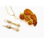 A continental yellow metal and amber brooch, a pair of yellow metal earrings and necklace, total