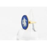 A 19th Century 18ct gold and Wedgwoodblue jasper dress ring, the navette shaped blue panel decorated