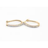 A pair of 9ct gold hoop earrings, the eight cut diamonds in white gold claw setting on a 9ct gold