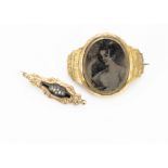 A 19th Century gilt mounted mourning brooch, converted from a bracelet, centred with a