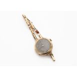 A c1930s 9ct gold lady's wristwatch, octaoganal on a 9ct gold expanding strap, 15g