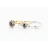 Three 9ct gold rings, including a diamond solitaire in white gold, ring size P, and two cluster