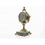 An early 20th century French gilt and porcelain mantle clock, circulaur case with turquoise