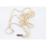 A three strand graduated cultured pearl knotted strung necklace, the pearl strings united by a