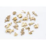 A collection of gold charms, including a comical shooting dog with deerstalker hat and shotgun, a