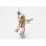 A modern silver and enamelled clown from Mappin & Webb, modelled standing on one leg on a skatebaord