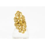 A yellow metal Middle Eastern filigree ring, of oval pierced design with rope twist shank, 11g, ring