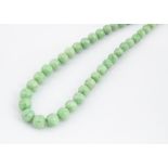 WITHDRAWN A graduated string of jade beads, the spherical polished beads