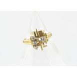 An 18ct gold modernist diamond set ring, the linear abstract setting surmounted with three small