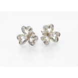 A pair of 18ct gold diamond set flower head stud earrings