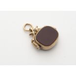 A 9ct gold bloodstone and cornelian swivel fob, the gold mount with spinning arched bracket,