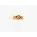 A Victorian three stone coral ring, the gypsy set coral cabochon beads in rubbed over setting all in