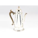 A 1960s silver coffee pot by W.W, the Georgian style tapered pot with hinged dome lid, London