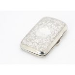 An Edwardian silver cigar case by TH, rectangular and curved with engraved scrolling foliage and