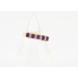 A 14ct gold ruby and diamond half hoop eternity ring, the five step cut/baguette cut rubies