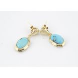 A pair of yellow metal and turquoise drop earrings, the oval polished cabochons in a plain collet