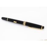 A modern Mont Blanc Meisterstuck fountain pen, black with gold mounts, two tone 14ct gold nib marked