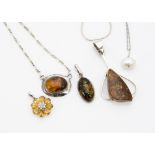 Two silver amber set pendants, another citrine flower head silver set pendant, amber necklace, a