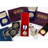 A small collection of coins and medals, including a 1937 crown, other modern cupro-nickel crowns,
