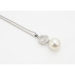 A contemporary 18ct gold scroll set pendant with cultured pearl drop, 23cm fastened