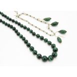 A malachite graduated bead necklace, with rough pebble shaped stones, 57cm long together with a seed