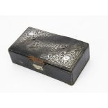 An Edwardian bridge box, black leatherette with silver mounts and word Bridge, with some cards