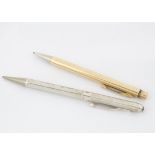 A 1970s silver retractable pencil, together with a gold plated Eversharp retractable pencil (2)