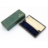 A late 1950s Rolex box, green with gilt decoration, green velvet watch support, possibly for