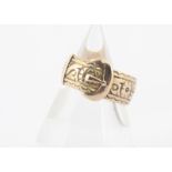 A George V 9ct gold buckle ring, with engraved decoration of flowers and scrolls, hallmarked to